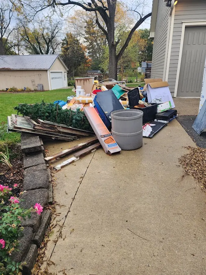 Dumpster being loaded with debris for 12 Yard Dumpster Rental in Chackbay